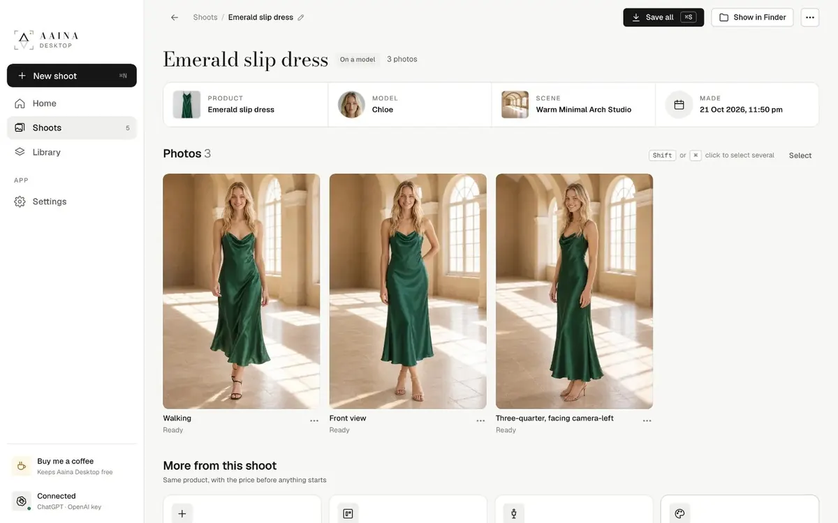 Aaina Desktop showing a finished shoot: an emerald slip dress on a model in a warm arched studio, three photos ready to save