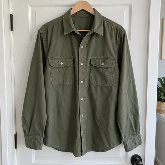 The seller's phone photo: the overshirt on a hanger on a door